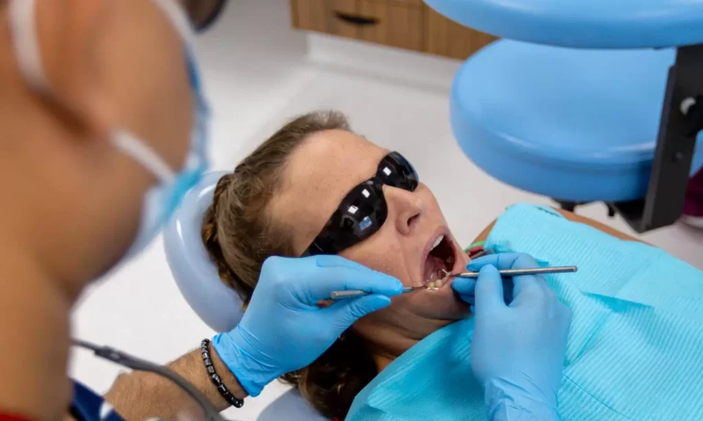 Dentist examining a patient's teeth in the treatment chair at Carina Gardens Dental in Carina, Brisbane