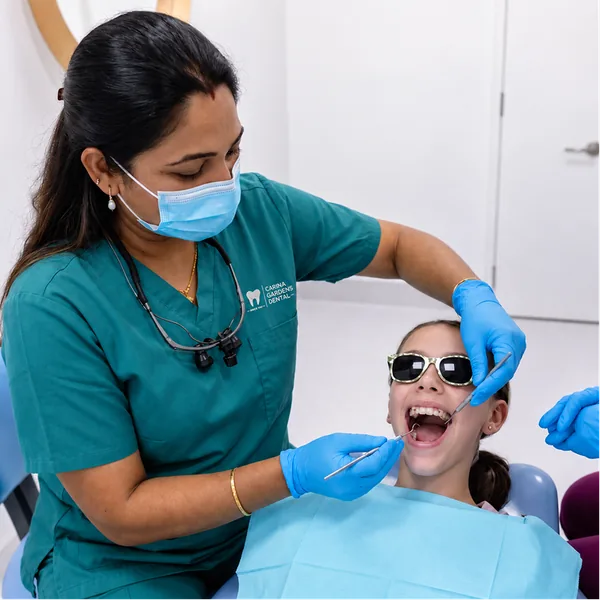 Dentist checking a smiling child's teeth during a children's dental visit at Carina Gardens Dental, Carina Brisbane