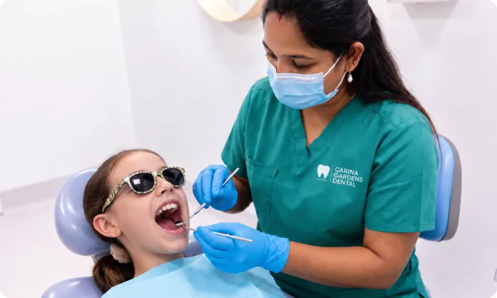 Dentist examining a young patient's teeth during a general dentistry check-up at Carina Gardens Dental, Carina Brisbane