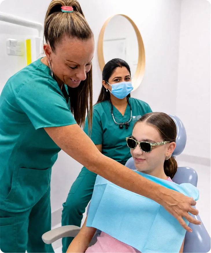 Dental team member helping a young patient settle into the dental chair at Carina Gardens Dental, Carina Brisbane